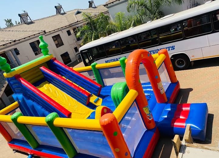 Inflatable jumping castle with the Muthathe Students shuttle bus in the background