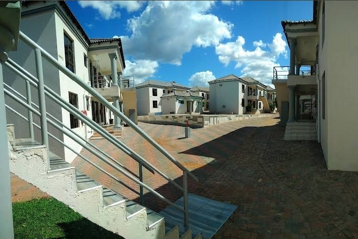 Courtyard walkway between residence blocks at Muthathe Student Village
